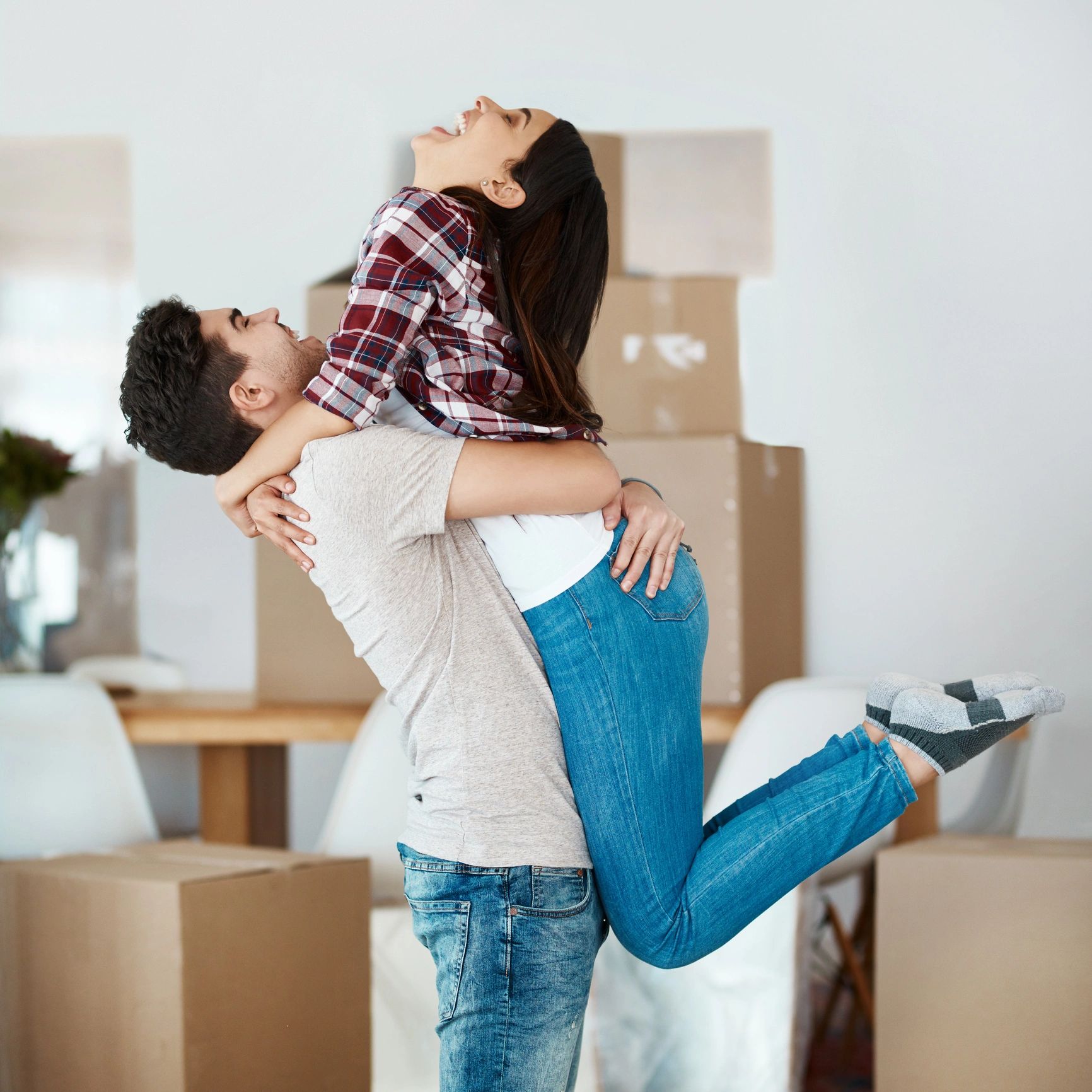 Couple smiling while moving into a new home